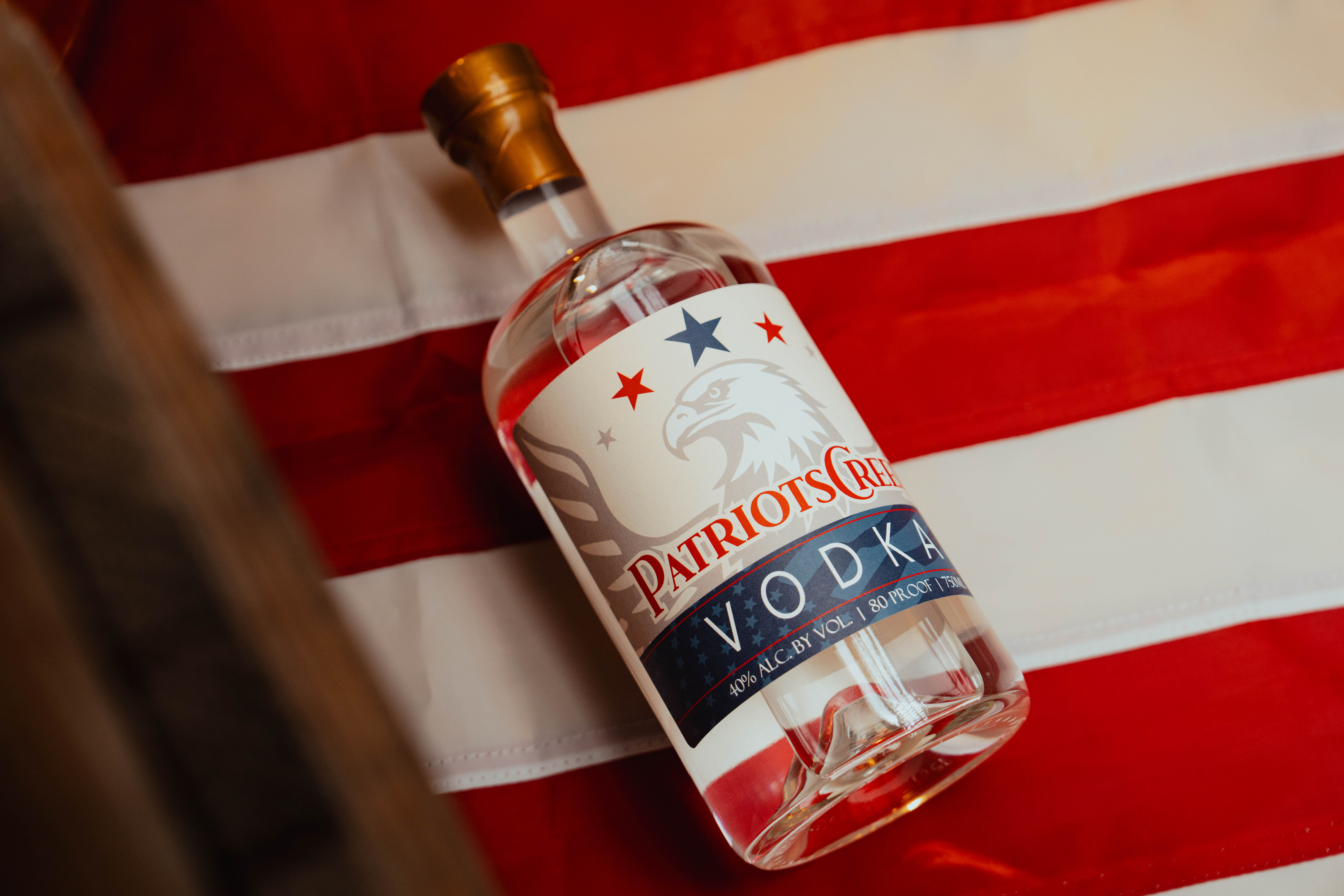 Patriot's Creed Vodka Bottle - Professionally photographed. Sitting atop an American flag.